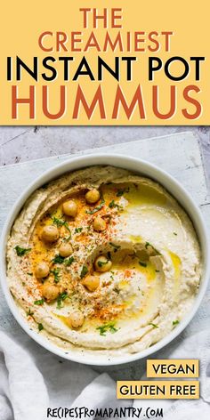 a bowl filled with hummus and garnish on top of a white cloth