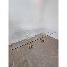 a glass coffee table with gold legs in an empty room