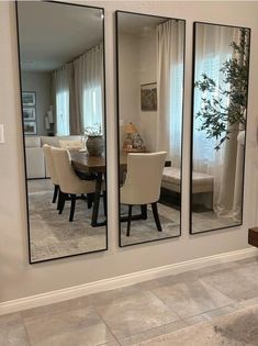 three mirrors reflecting the dining room and living room