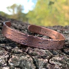 A rustic handmade bracelet that celebrates the beauty of nature and the majesty of the forest with the tree bark texture of this solid copper cuff bracelet. The inside is the perfect place to have your gift personalized with a secret message of love. This engraved copper bracelet is hand forged and finished with a hammered finish to give it a rustic look, perfect for men and women alike. Each bracelet is handmade, and no two will be exactly alike. Also please be aware that colors may vary due to Rustic Bangle Cuff Bracelet As Gift, Stamped Copper Cuff Bracelet For Gift, Stamped Copper Cuff Bracelet As Gift, Rustic Stamped Cuff Bracelet Gift, Handmade Rustic Bronze Bracelets, Electroformed Copper Cuff Bracelet Gift, Rustic Stamped Bracelets For Gifts, Rustic Stamped Bracelets For Gift, Handmade Rustic Cuff Bracelet As Gift