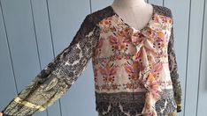 "#vintagebohochic This boho summer colorful blouse is in lightweight chiffon and lace. Classic paisley prints Ruffle front  3/4 sleeves Elastic waist Best fits : S and smaller M  Perfectly paired with denim outfits. Or with light color pants. In Measurements(taken flat): Bust: 17\" Waist: 14\" - 17\" elastic Total Length: 26\" Made in India Excellent vintage condition. To see more items, visit : www.etsy.com/shop/RetroTheory" Bohemian V-neck Blouse With Ruffles, Bohemian Fitted Ruffle Blouse, Bohemian Blouse With Vintage Print For Fall, Bohemian Fitted Blouse With Ruffles, Bohemian Patchwork Blouse For Spring, Bohemian Spring Blouse With Patchwork, Summer Festival Ruffled Blouse, Bohemian Spring Patchwork Blouse, Spring Bohemian Patchwork Blouse