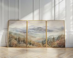 three paintings on the wall in an empty room with wood flooring and white walls