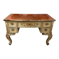 an antique desk with two drawers on one side and gold leaf decoration on the other