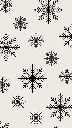 black and white snowflakes on a light gray background seamless wallpaper pattern