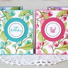 two cards with flowers on them and the words thank you written in blue, green, pink