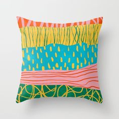 a colorful pillow on a white wall