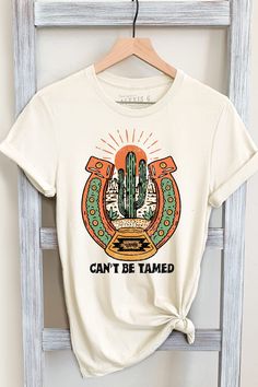 CAN'T BE TAMED GRAPHIC TEE Our Shirts are Authentically Designed and Hand Screen Printed for Best Quality *Process where the ink is dyed into the shirt and graphic will not peel away -Proudly Hand Pressed in Los Angeles, CA. -30 Singles. 100% Washed Cotton -Comfortable and Very Soft -Style by Rolling up the Sleeves, Tie a Side Knot, Front Tuck... SIZE AND FIT *Please refer to the last photo option for measurements WASHING AND CARE -Machine Wash with Like Colors -Tumble Dry Low -Do Not Bleach -Do Tattoos Western, Western Graphics, Country Graphic Tees, Can't Be Tamed, Cactus Desert, Western Graphic Tees, Western Clothing, Front Tuck, Cowgirl Shirts