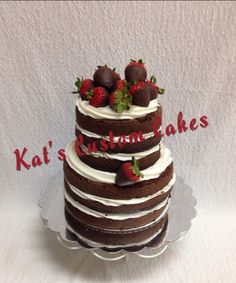 a three layer chocolate cake with strawberries on top