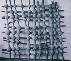 an old photo of some kind of structure made out of rope and wood sticks on a wall