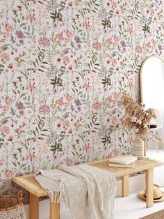 a floral wallpaper with pink flowers and green leaves in a room next to a mirror