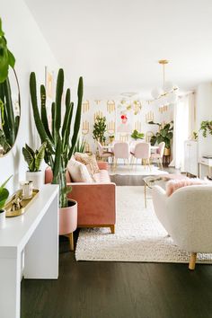 a living room filled with furniture and lots of plants