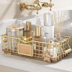 a bathroom sink filled with lots of gold items