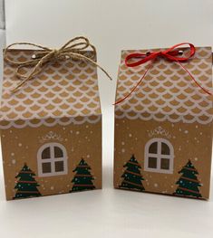 two brown paper bags with houses on them