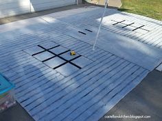 the roof is being painted with white paint and some black dots on it's surface