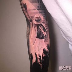 a man's arm with a black and white tattoo of a cowboy on it