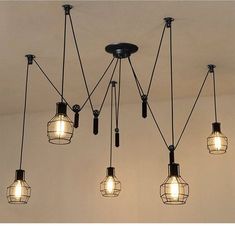 five light bulbs hanging from the ceiling with words on it that say pulley for adjustments