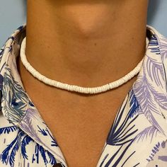 Experience the exotic beauty of the Elios White Shell Puka style Men Necklace! Made in the USA. This 14Kt gold-filled necklace is 16-17" long and sure to bring you seaside vibes wherever you are. A stylish addition to any look, its perfect for a beach day or a casual evening. Live seaside living with this unique statement piece! Puka Shell Necklace Men, Adjustable Single Strand Necklace For Vacation, Adjustable Single Strand Jewelry For Vacation, Minimalist Adjustable Necklaces For Beach, Minimalist Beach Choker Jewelry, White Single Strand Necklace For Beach, Single Strand Choker Necklace For Beach, Seashell Necklace Diy, Puka Shell Necklace