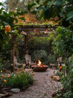 an outdoor fire pit surrounded by chairs and trees