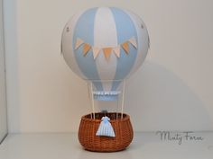 a blue and white hot air balloon in a basket