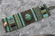 a beaded bracelet on top of a rock