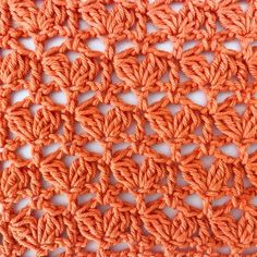 an orange crochet pattern on a white surface