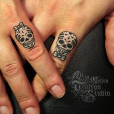 two people with matching tattoos on their fingers