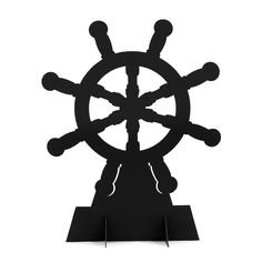 a clock that is sitting on top of a stand in the shape of a ship's wheel