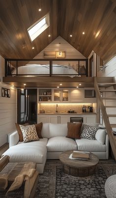 This loft-style tiny home is a perfect example of how small spaces can pack in major design appeal. With a cozy loft bedroom that overlooks the living space, this tiny home manages to feel spacious while maintaining an intimate, welcoming vibe. The sleek kitchen features modern cabinetry, high-end finishes, and just enough room to make cooking a breeze—proving you don’t need to give up gourmet meals just because your home is smaller. Whether you’re considering downsizing or just love good design, this tiny home is loaded with inspiration. Ready to explore more stunning luxury tiny homes that maximize every inch with style? Head over to our site and get all the ideas you need to create your own high-end, small-space retreat. Tiny Home With Large Loft, Cozy Interior Design Small Houses, Tiny Home Space Savers, Luxury Tiny House Interior, Tiny Loft Ideas, Small Loft House Design, Garage Tiny House, Cozy Small Home, Cozy Loft Bedroom