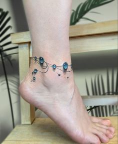 a woman's foot with a tattoo on it