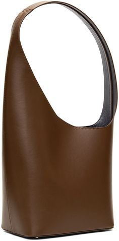 Structured buffed calfskin shoulder bag in brown. · Fixed shoulder strap · Logo embossed at face · Bumper studs at base · Magnetic closure · Patch pocket at interior · Faux-leather lining · H8.5 x W7.5 x D5 in Supplier color: Praline Luxury Streetwear, Magnetic Closure, Patch Pocket, Designer Fashion, Calf Skin, Shoulder Strap, Faux Leather, Perfect Clothing, Shoulder Bag