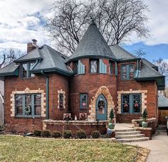 a large brick house with a turret roof