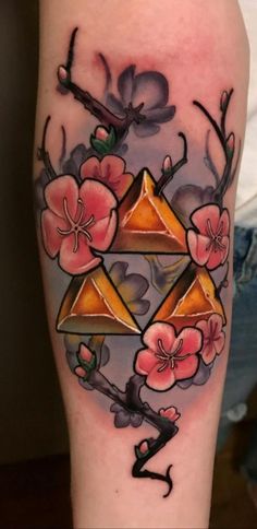 a tattoo with flowers and triangles on it