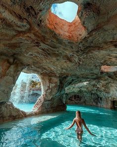 a woman standing in the middle of a pool