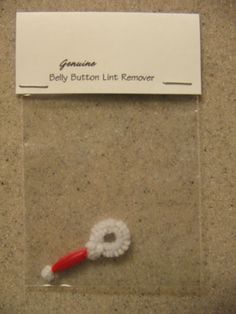 a red and white toothbrush sitting on top of a counter