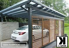 a white car is parked in front of a carport with wood slats on it