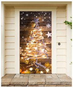 a decorated christmas tree on a wooden door with snowflakes and stars around it