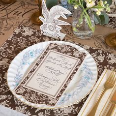 a table setting with plates, silverware and napkins