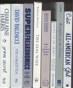 the books are lined up neatly on the book shelf, all in blue and white