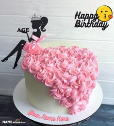 a heart shaped cake with pink frosting and a woman's silhouette on top