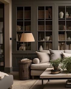 a living room filled with lots of furniture and bookshelves