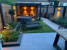 an outdoor patio with seating and lights