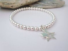 "These elegant handmade 925 sterling silver beaded double star charm bracelets feature 4mm sterling silver beads, star charms and stretch, making them easy to slip on and off, ideal for stacking and for easy everyday wear - the perfect keepsake bracelet. - Why not treat yourself or someone special! - Super fast despatch. THE PERFECT BEAD BRACELET - 100% sterling silver bracelet. - 17mm open / silhouette star charm - 10mm mini solid star charm - Professional jewellers elastic cord - Co-ordinating Silver Star Bracelet, Beaded Stacking Rings, Sterling Silver Birthstone Ring, Celestial Jewelry, Star Bracelet, Bracelet Beaded, Heart Beads, Sterling Silver Heart, Star Charms