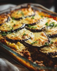 an eggplant casserole with cheese and herbs in a glass baking dish