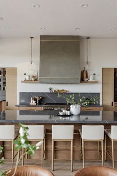 the kitchen is clean and ready to be used for cooking or eating, with chairs around the island