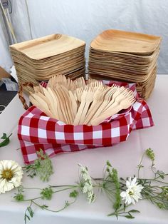 a table topped with lots of wooden utensils and flowers next to each other