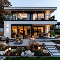 a modern house is lit up at night