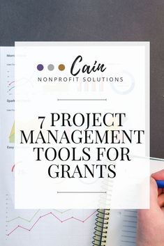 a hand holding a pen over a paper with the title 7 project management tools for grants