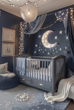 a baby's room decorated in blue and white with stars, moon and crescent decorations