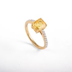 This ring with beautiful Natural Yellow sapphires, is set in 18K Solid Yellow Gold. It is a band ring perfect for any gifting occasions for your loved ones. Purchase the perfect gift for your mom, wife, daughter, girlfriend, and fiancee. This ring, due to its minimalist design, can also be stacked easily with other statement rings. -Material - 18K Solid Yellow Gold -Gemstone - Genuine Yellow Sapphire Diamond -Gemstone weight - 1.830 ct -Diamond Weight - 0.210 Ct -Gross weight - 3.05 grams Yellow Yellow Sapphire Gemstone Promise Ring, Yellow Sapphire Ring With Center Stone In Yellow Gold, Elegant Yellow Sapphire Promise Ring, Fine Jewelry Yellow Sapphire Ring Gift, Yellow Sapphire Ring Fine Jewelry Gift, Yellow Sapphire Ring With Prong Setting For Weddings, Oval Yellow Sapphire Ring With Prong Setting, Elegant Yellow Sapphire Ring With Halo Setting, Classic Yellow Sapphire Diamond Ring