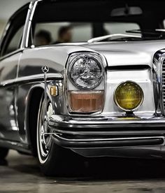 the front end of an old silver car